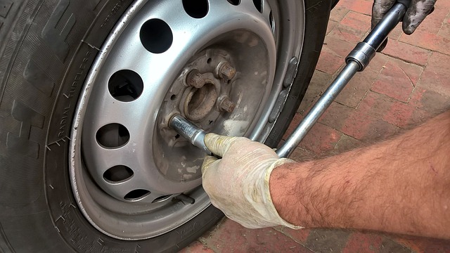 A photo of a man changing tires