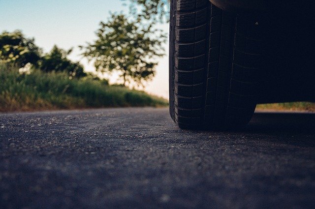 A photo of a car tire on the road