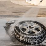 a car tire being hosed down