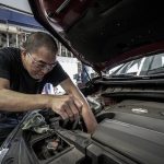 man changing engine oil