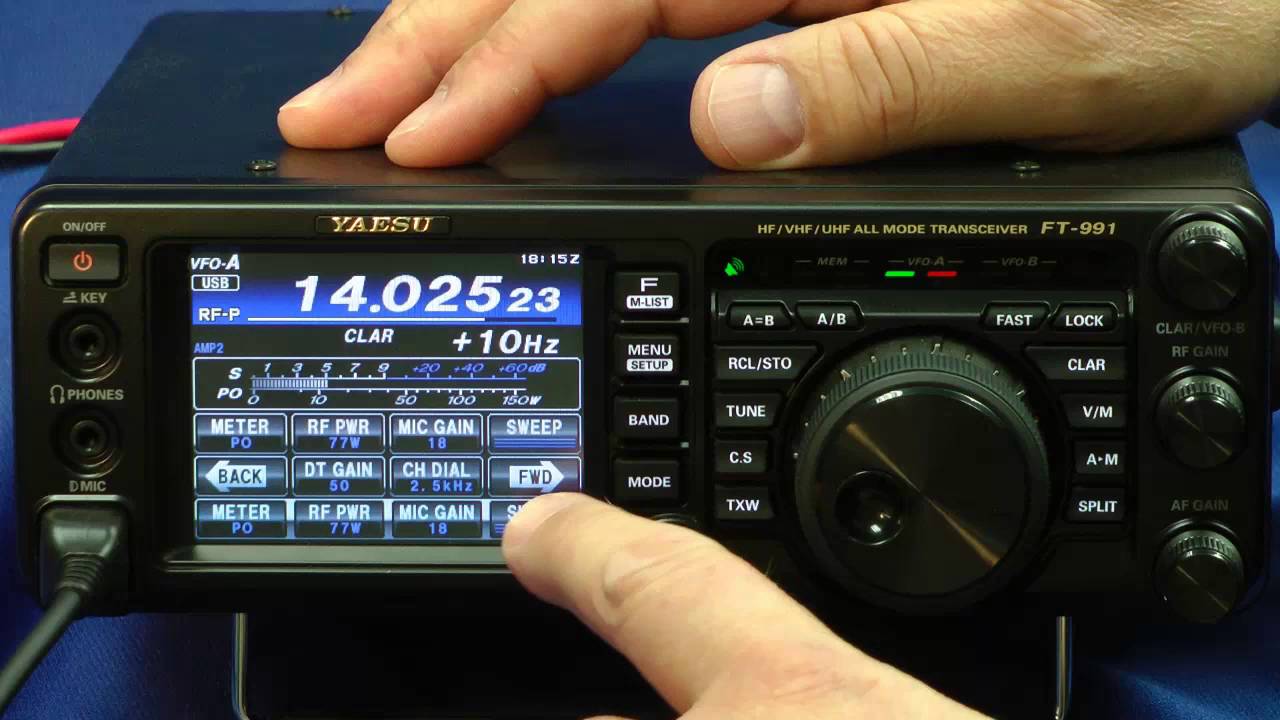 Yaesu FT-991 in use with two hands adjusting the settings