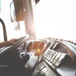 person's hand on steering wheel