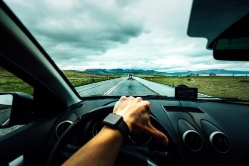 hand maneuvering the car wheel