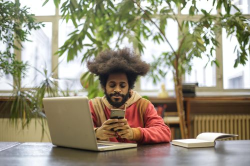 man in long sleeves using laptop