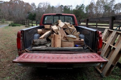 old pickup truck loaded down with firewood