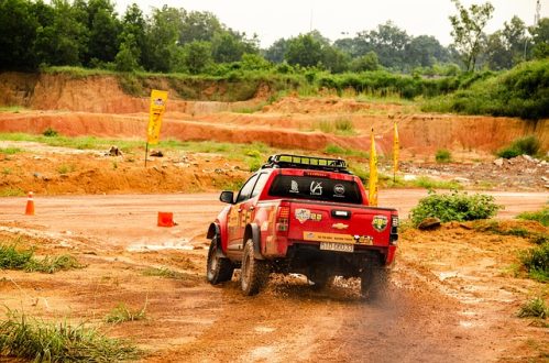pickup truck moving through dirt road