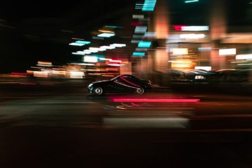 time lapse photo of car driven on the road at night