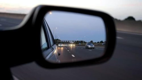view of the road through the side mirror