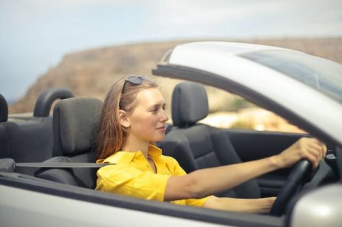 woman in yellow blouse driving